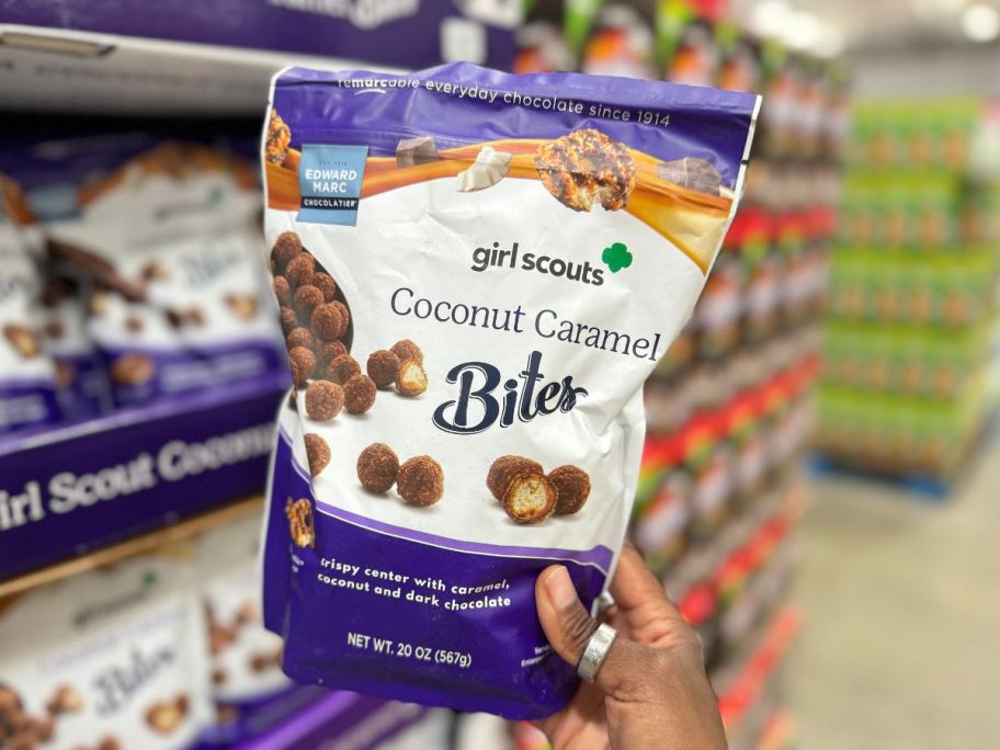 Girl Scouts Coconut Caramel Bites 20oz Bag being held by hand in store aisle