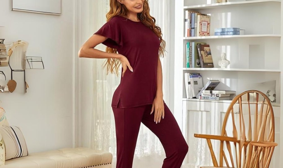 a model wearing a set of burgundy colored pajamas