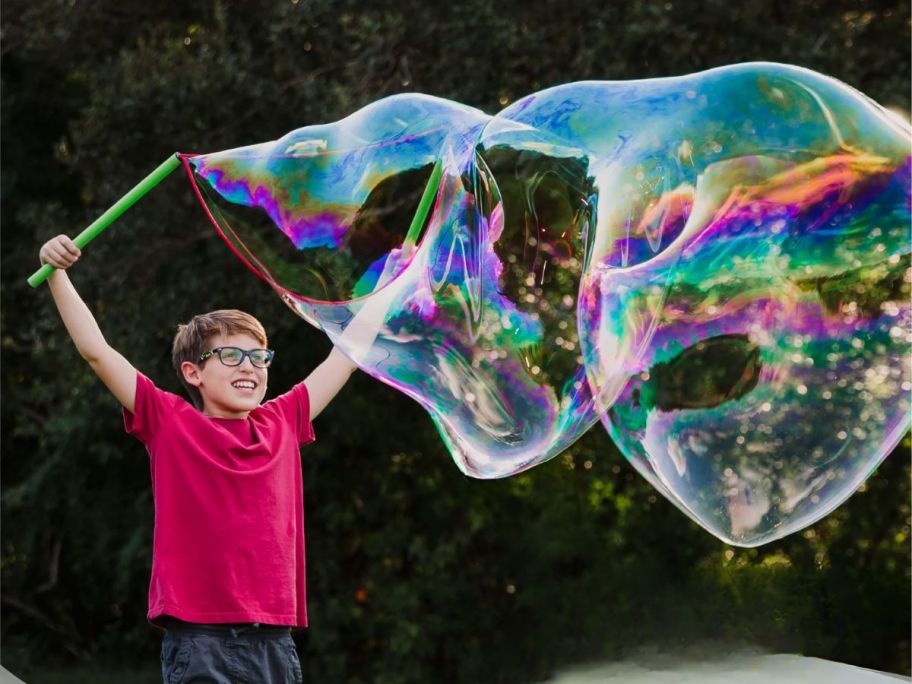 boy making bubbles with the WOWmazing Grab-N-Go Complete bubble Kit