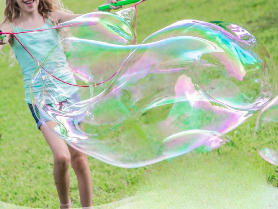 girl making bubbles with the WOWmazing Grab-N-Go Complete bubble Kit