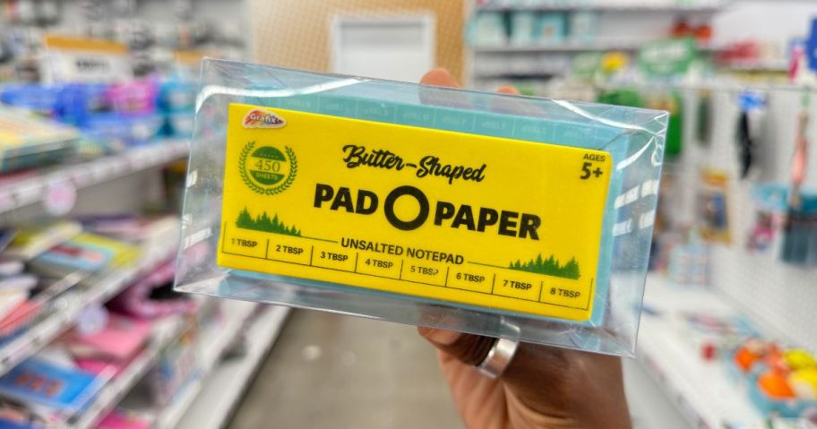 butter shaped pad o paper being held by hand in store