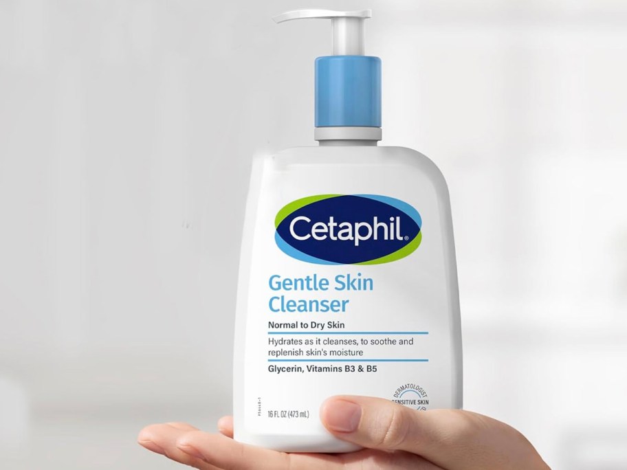 hand holding cetaphil skin cleanser bottle 