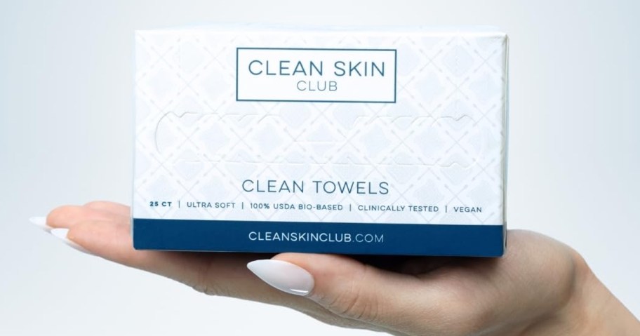 hand holding clean skin club wipes box 