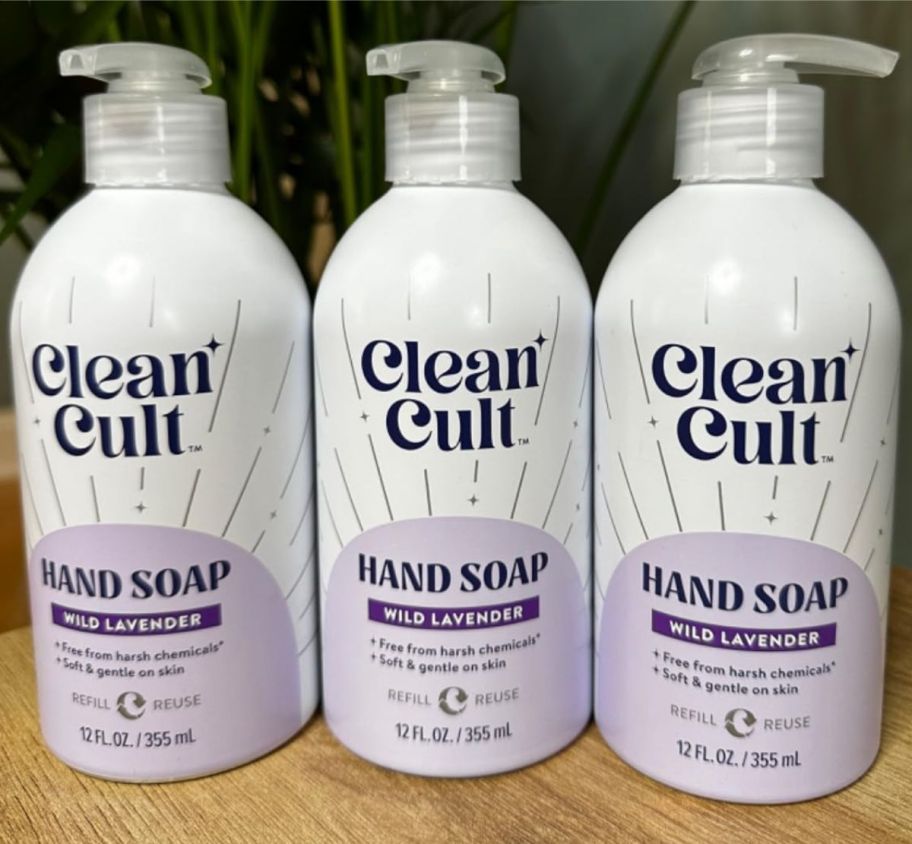 three bottles of liquid hand soap on a counter top