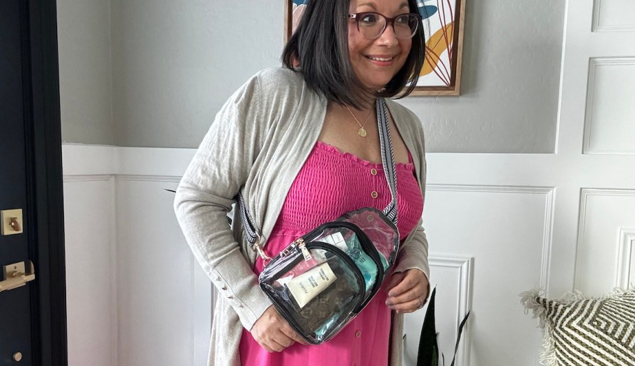 woman wearing clear crossbody with hot pink dress and gray cardigan