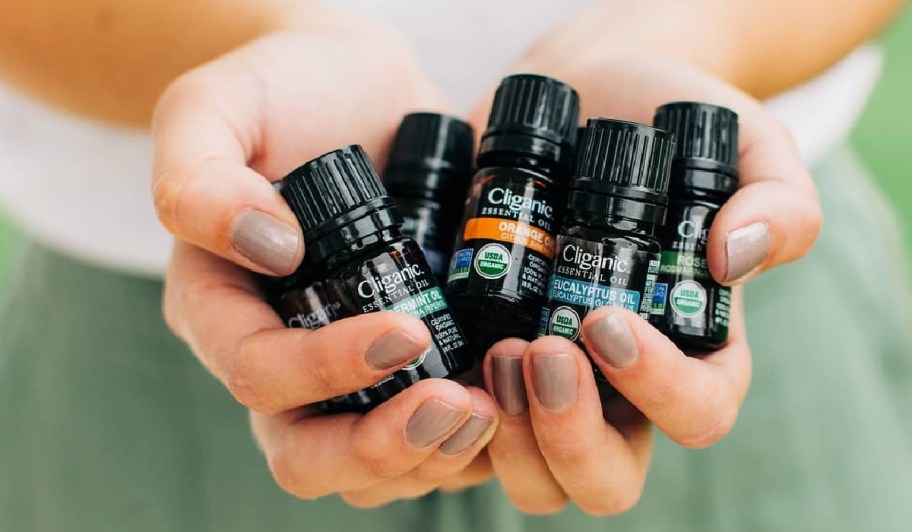 cliganic essential oils in a woman's hands