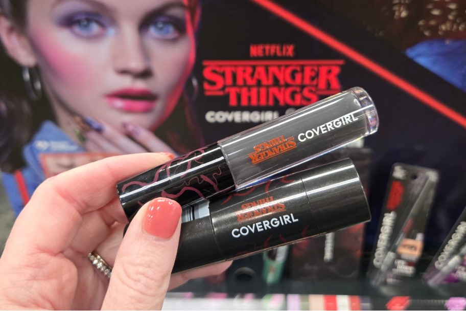 hand holding lip gloss and blush