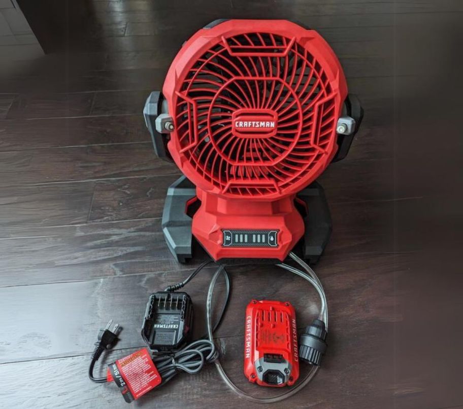 a red outdoor misting fan, charger and battery pack