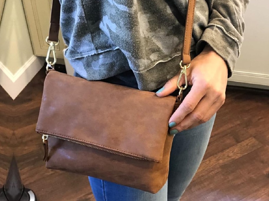 woman wearing brown crossbody bag