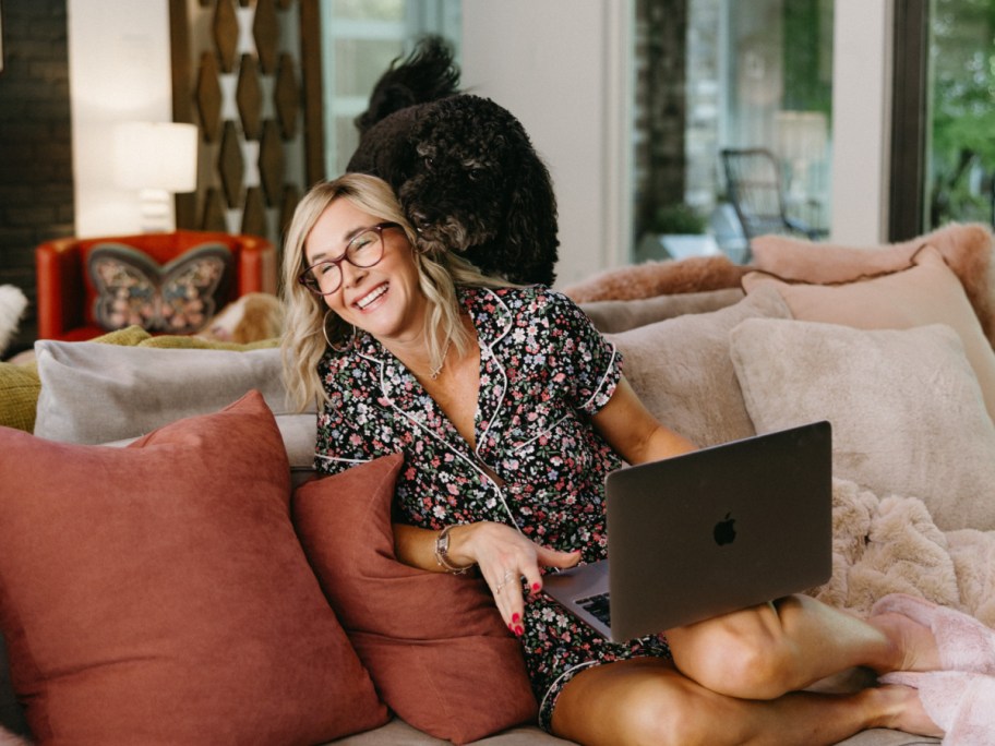 dog licking Collin on couch