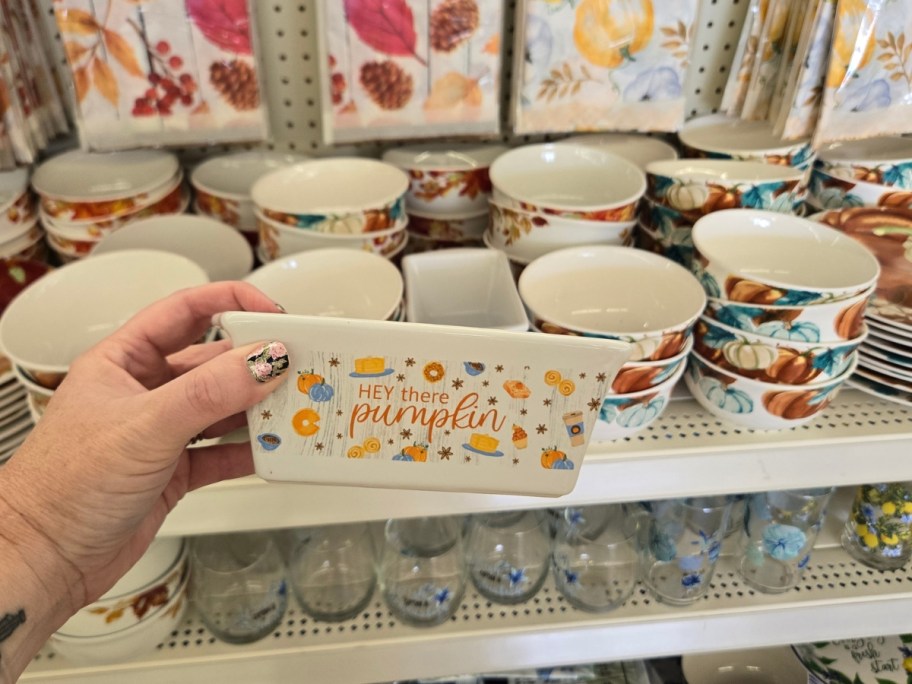 hand holding a butter dish with fall images that says "Hey there pumpkin"