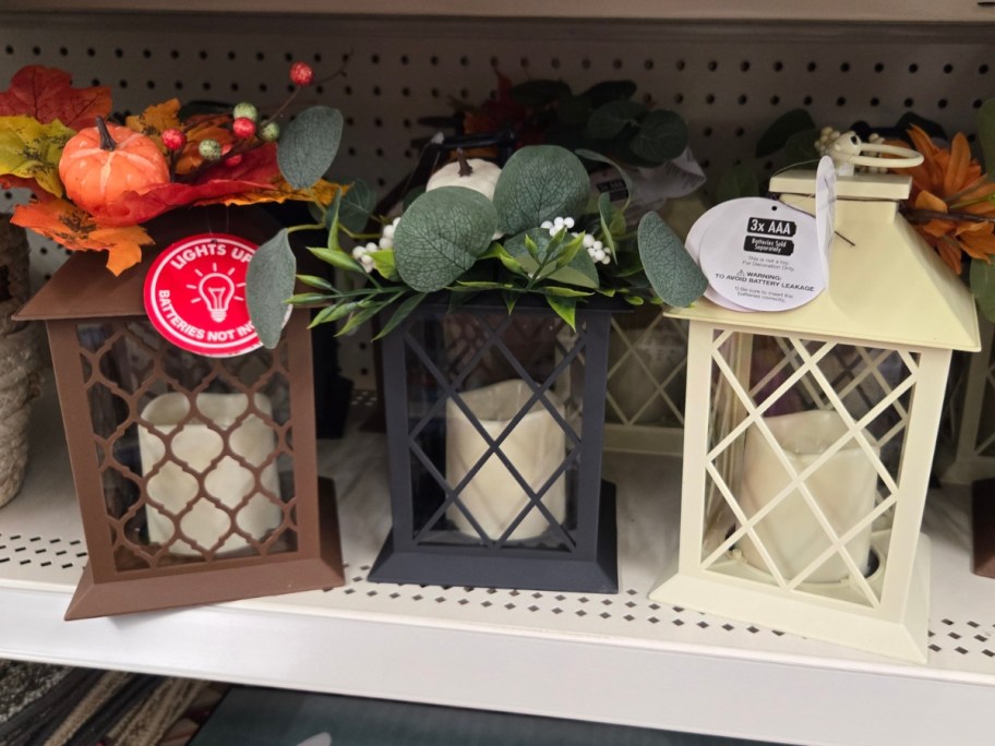 decorate fall lanterns with LED candles on a shelf
