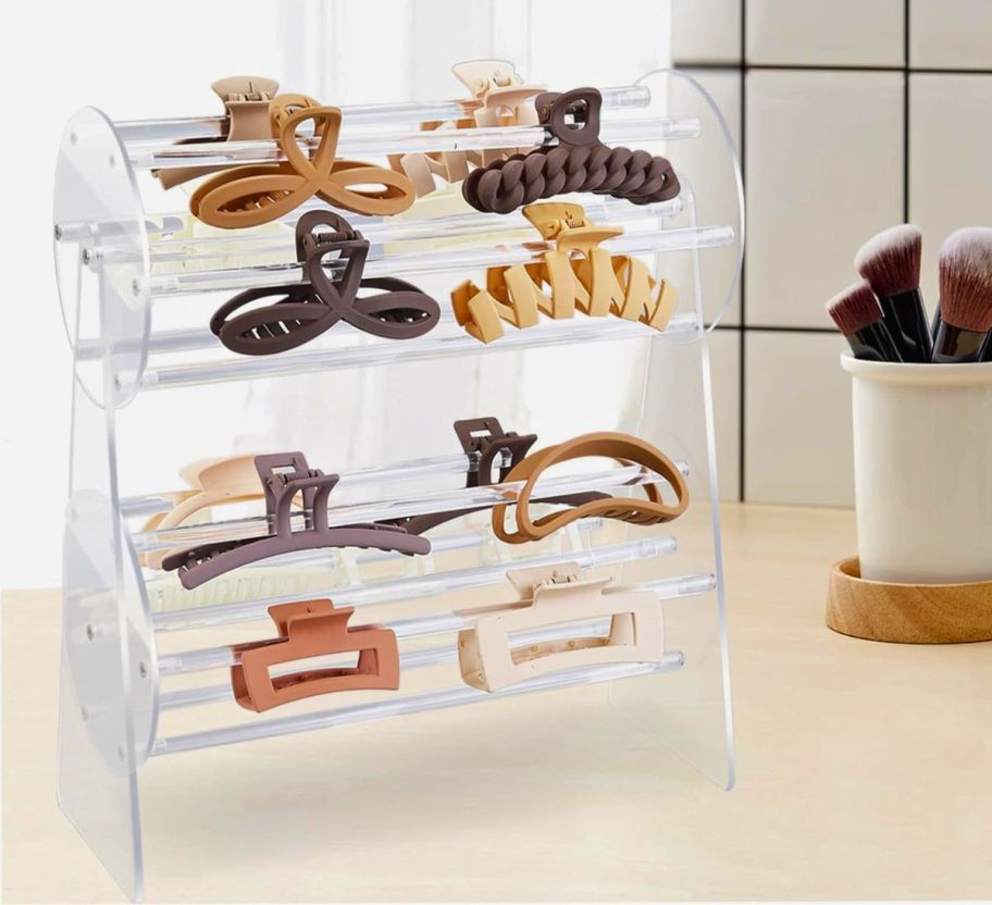a2-tier acrylic hair clip organizer loaded with hair clips on a countertop