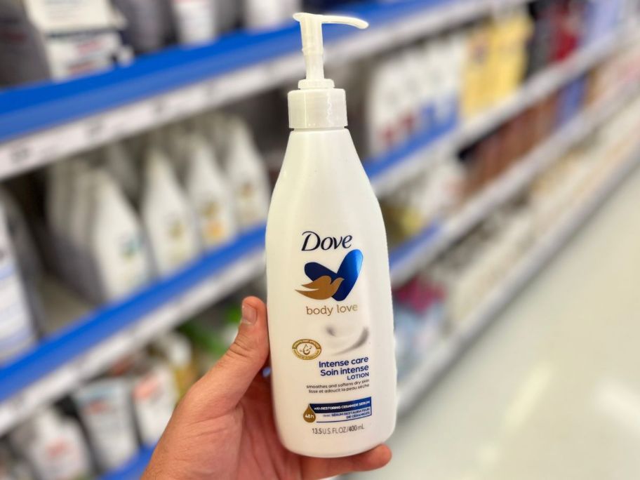 hand holding up dove body lotion in aisle