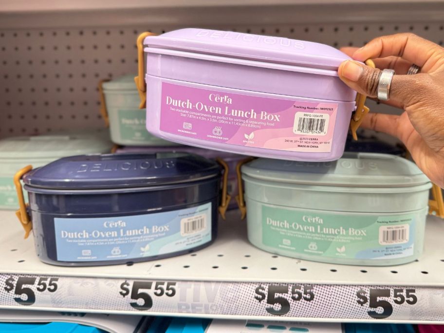 Dutch-Oven Lunch Box on store shelf and one being held by hand