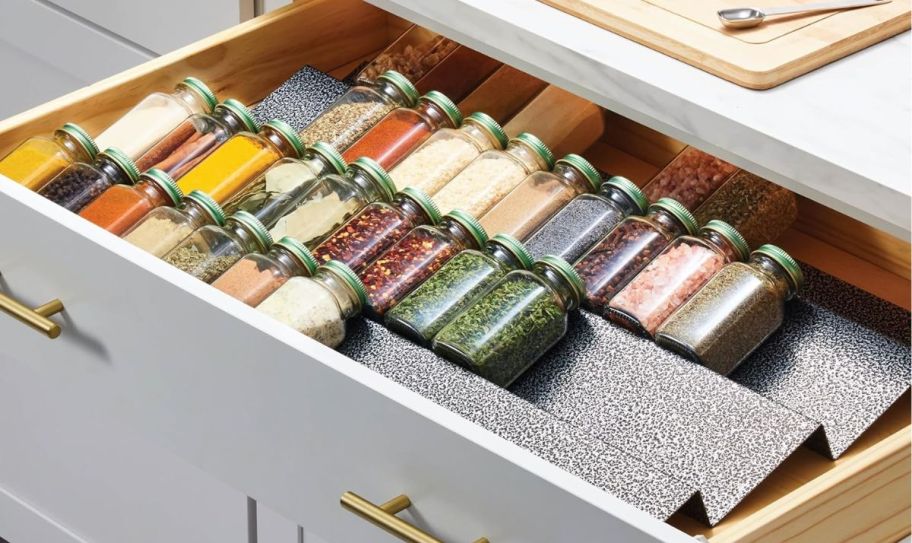 expandable spice organizer in a drawer with spice jars