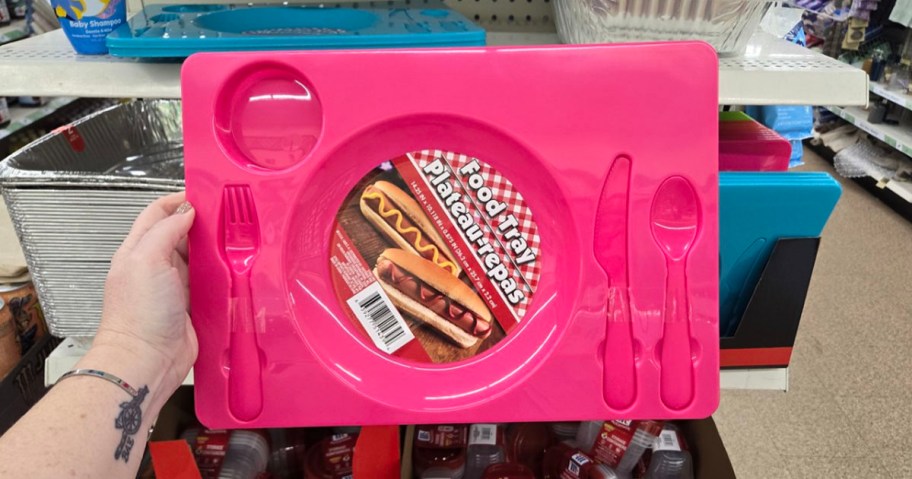 hand holding pink food tray 