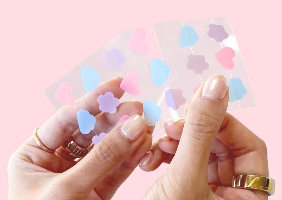 hands holding multi shape pimple patches