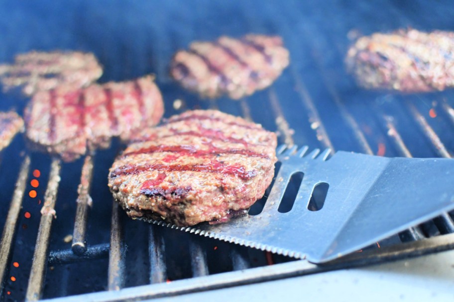 grilled burger on a spatula on the grill 