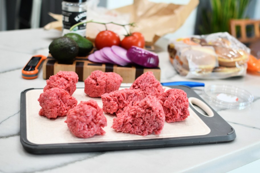 ground beef on a cutting board to make burgers