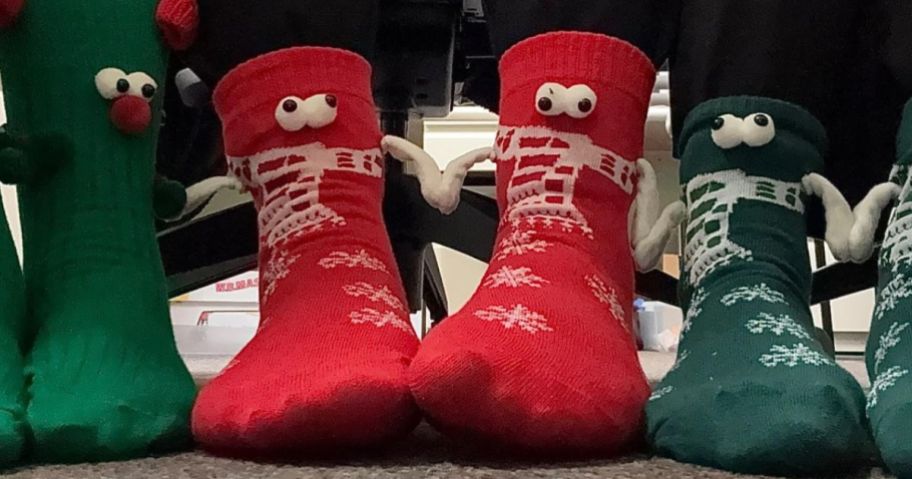 people wearing christmas hand holding socks