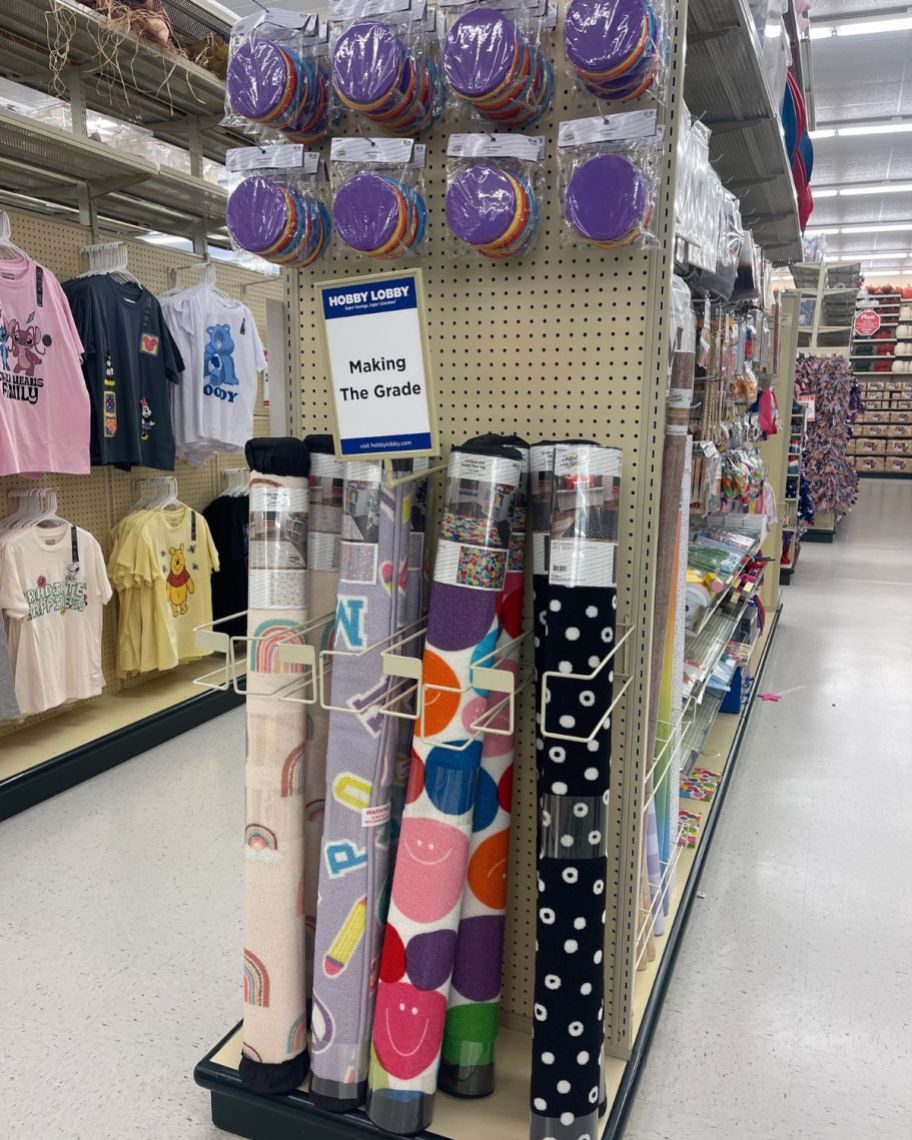 classroom rugs on an endcap in a store
