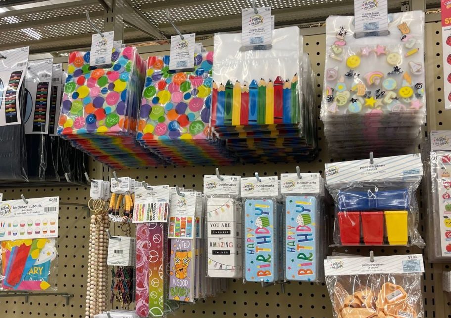 various teacher supplies hanging on a peg board in a store