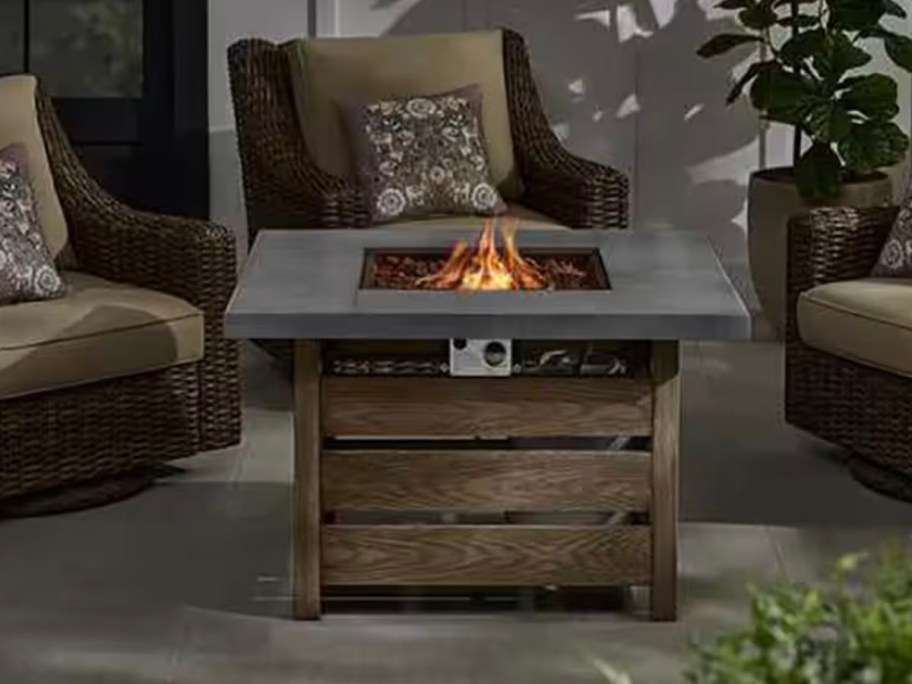 wood table firepit with fire on patio 
