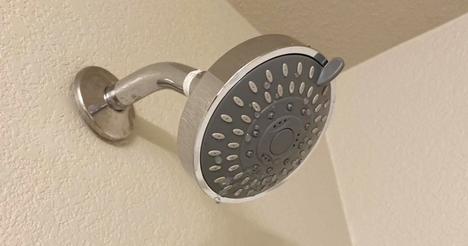 showerhead hanging on beige wall 