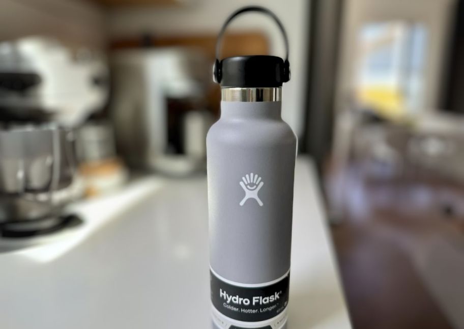 a stone colored hydro flask bottel on a kitchen counter