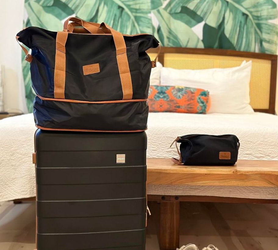 A carry-on luggage piece in black in a hotel room