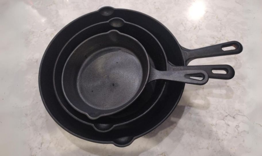 3 piece iron skillet set on a a counter top