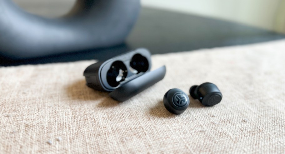 jlab ear buds displayed on top of the counter