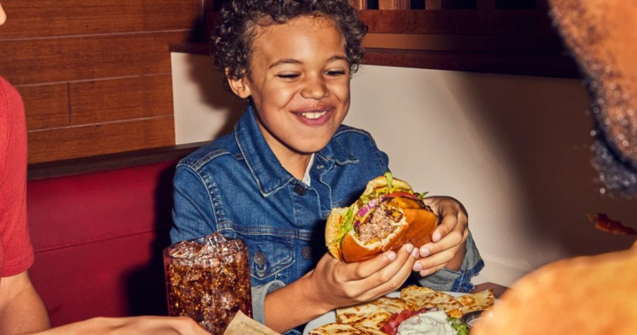 child eating a cheeseburger