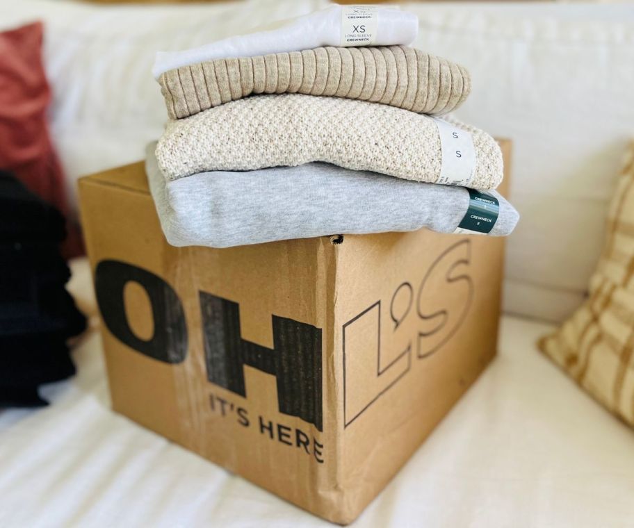 kohl's delivery box with sweaters on top of it