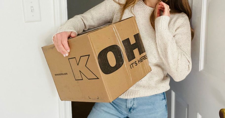 woman holding kohl's box in doorway
