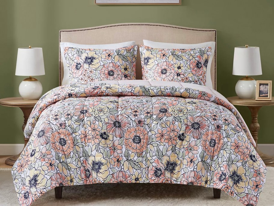 floral comforter set on bed with beige headboard 