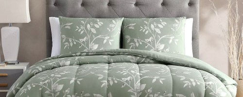 green floral comforter set on bed with matching pillows