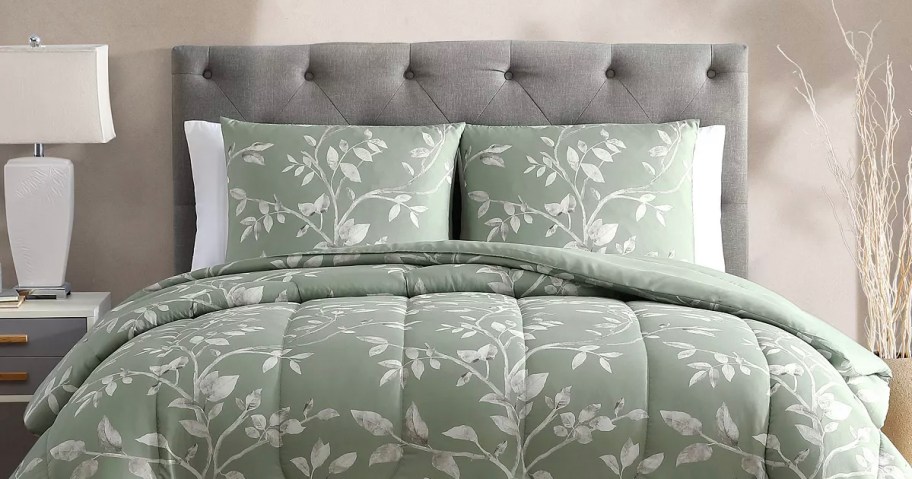green floral comforter set on bed with matching pillows 