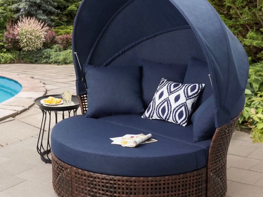 navy blue canopy daybed near pool 
