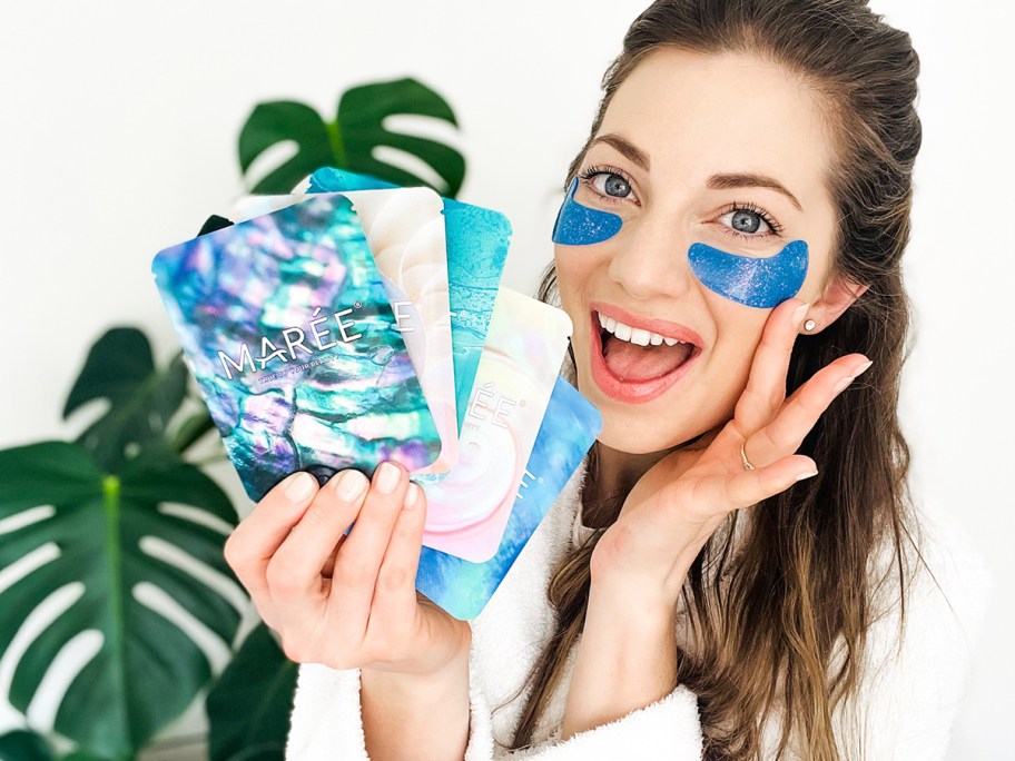 woman wearing blue eye gels holding packages 