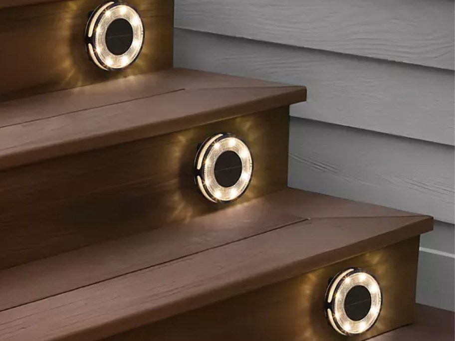 brown stairs with three solar lights hanging on them