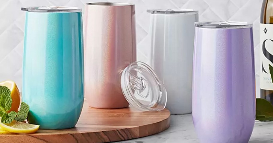 teal, pink, silver, and purple tumblers on countertop 