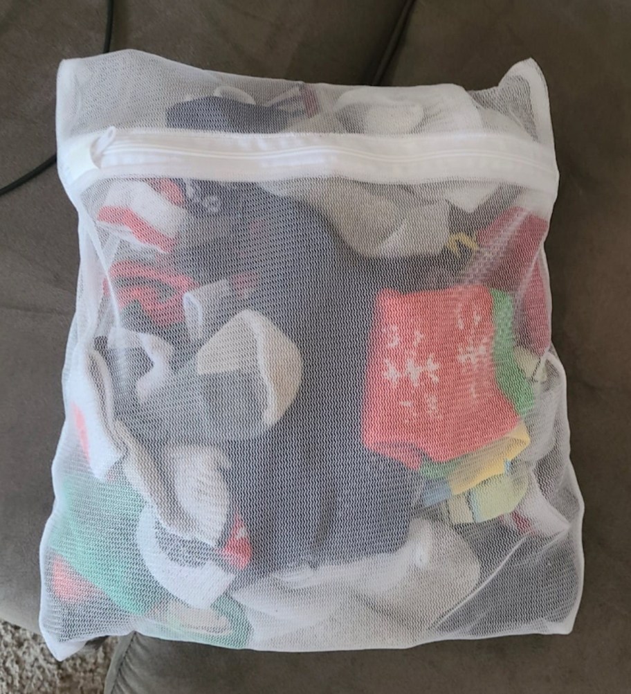 various kinds of socks in white mesh laundry bag