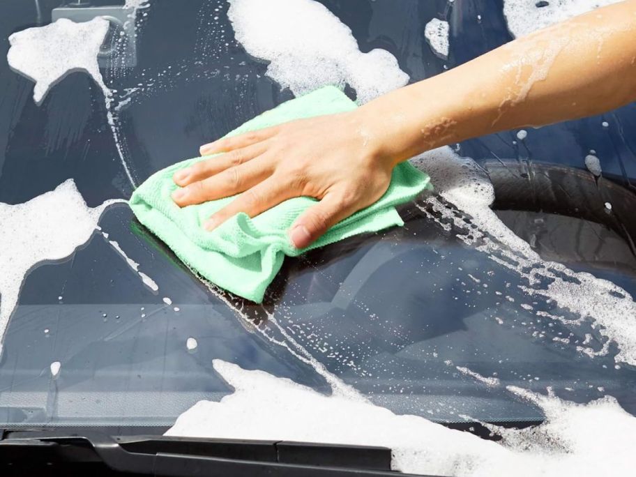Amazon Basics Microfiber Cleaning Cloths, Non-Abrasive, Reusable and Washable, Pack of 24 being used to wash a car