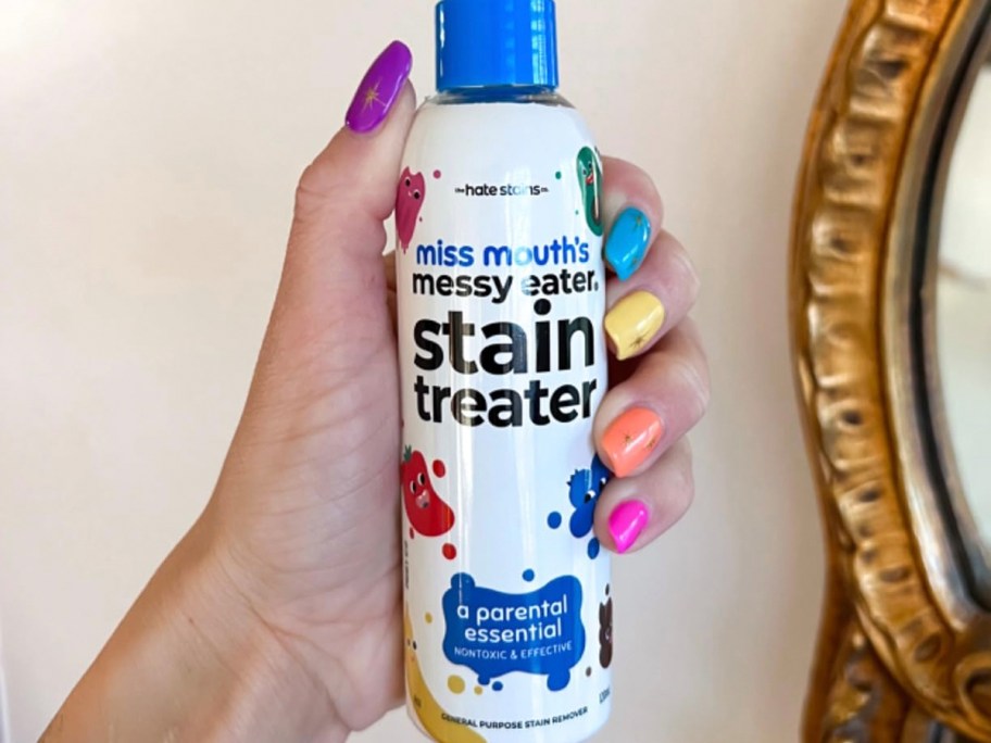 hand holding miss mouths stain remover bottle 