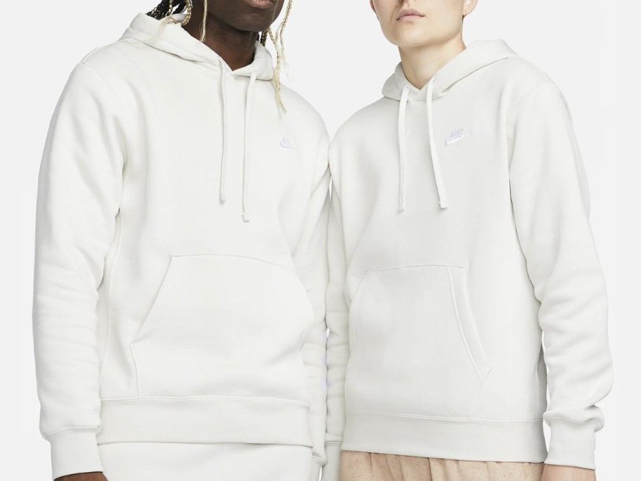 man and woman wearing white Nike hoodies