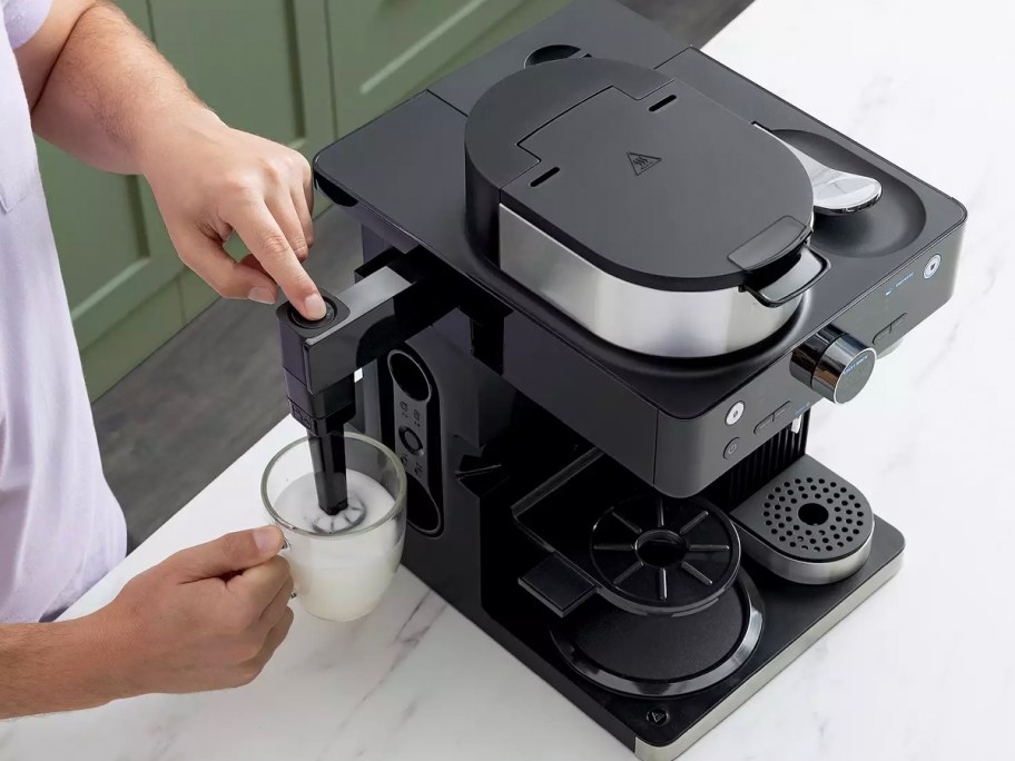 person using frother on ninja coffee maker 