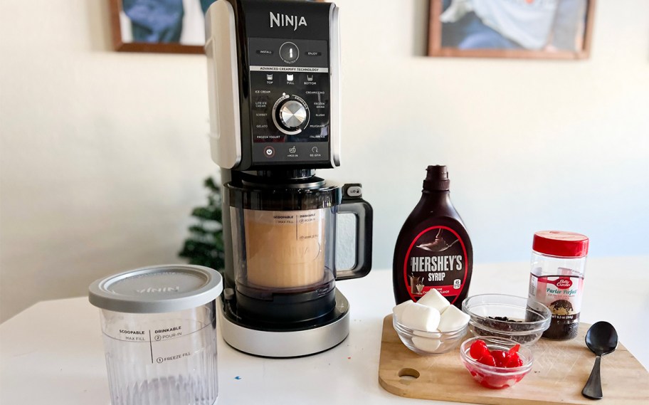 ninja creami on counter with marshmallows, chocolate syrup and more