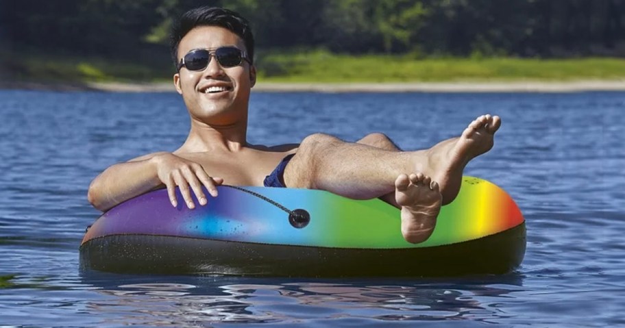 man in rainbow float on water